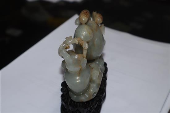 A Chinese pale celadon and russet jade quail carving, wood stand 10cm high including stand